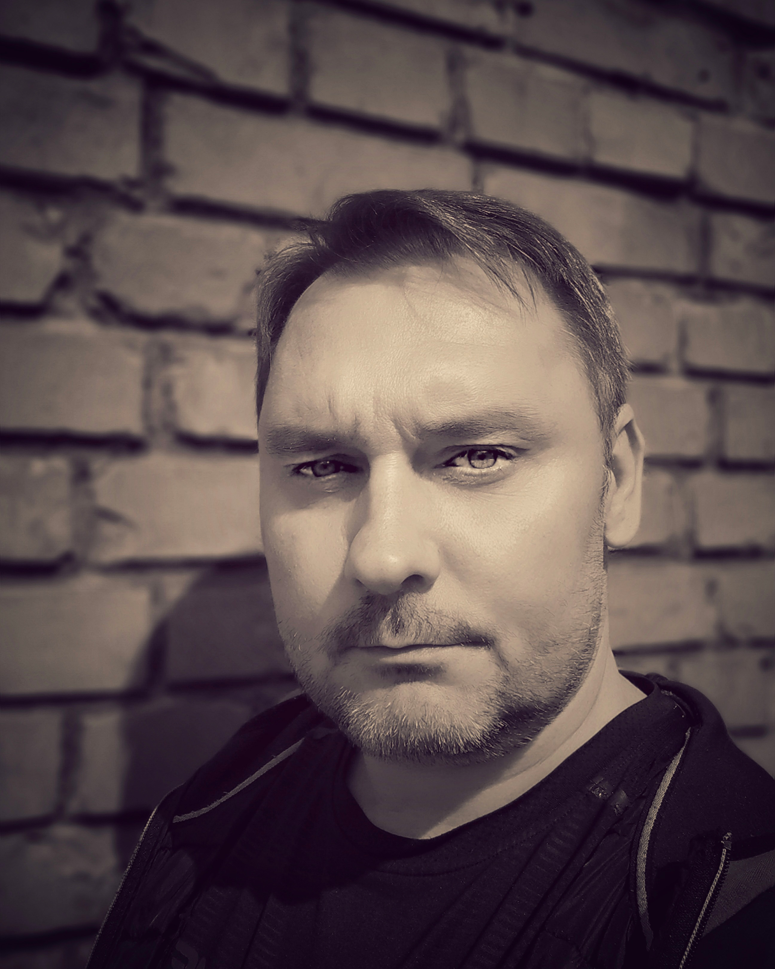 Portrait of OUTLAW2082 in a dark, modern visual setting